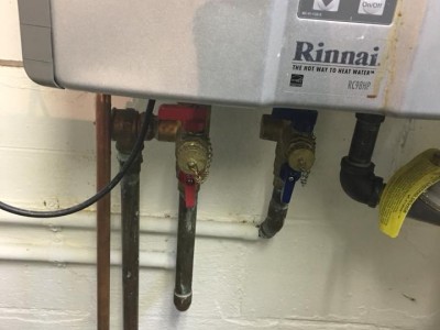 Pipe repaired below tankless water heater