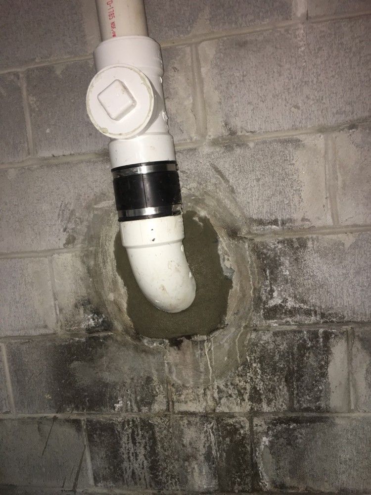 The repaired pipe with a new rubber coupling and cleanout