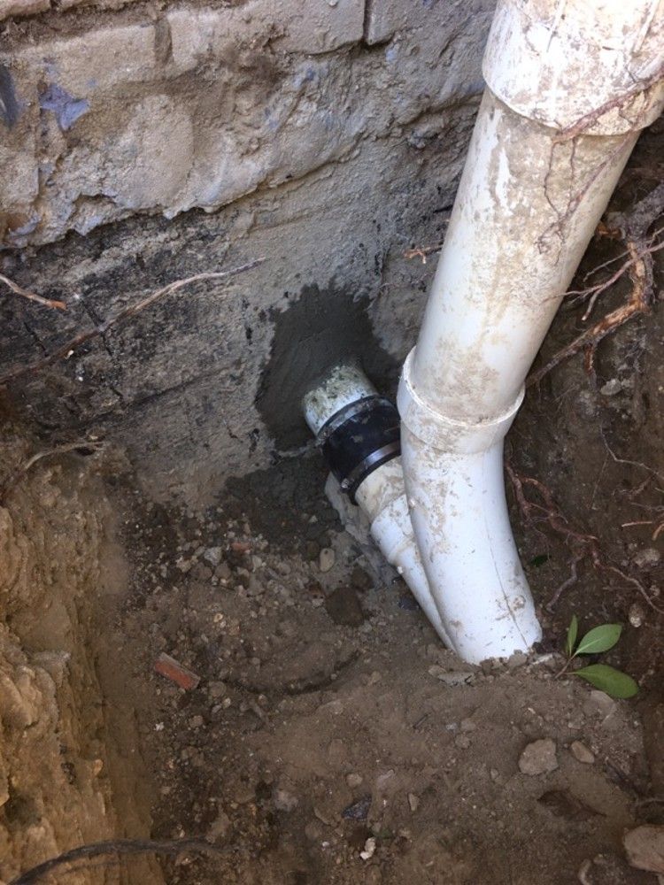 The repair outside, where the pipe leaves the house
