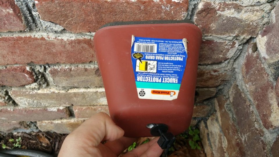 Pulling the cover over the outside faucet