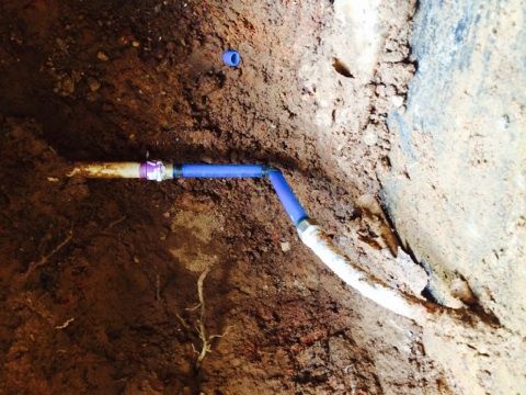 The new blue section joined to the old line with brass fittings