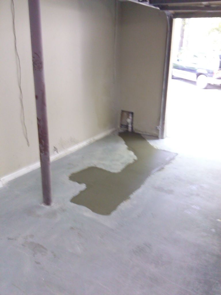 The concrete floor patched after the repair