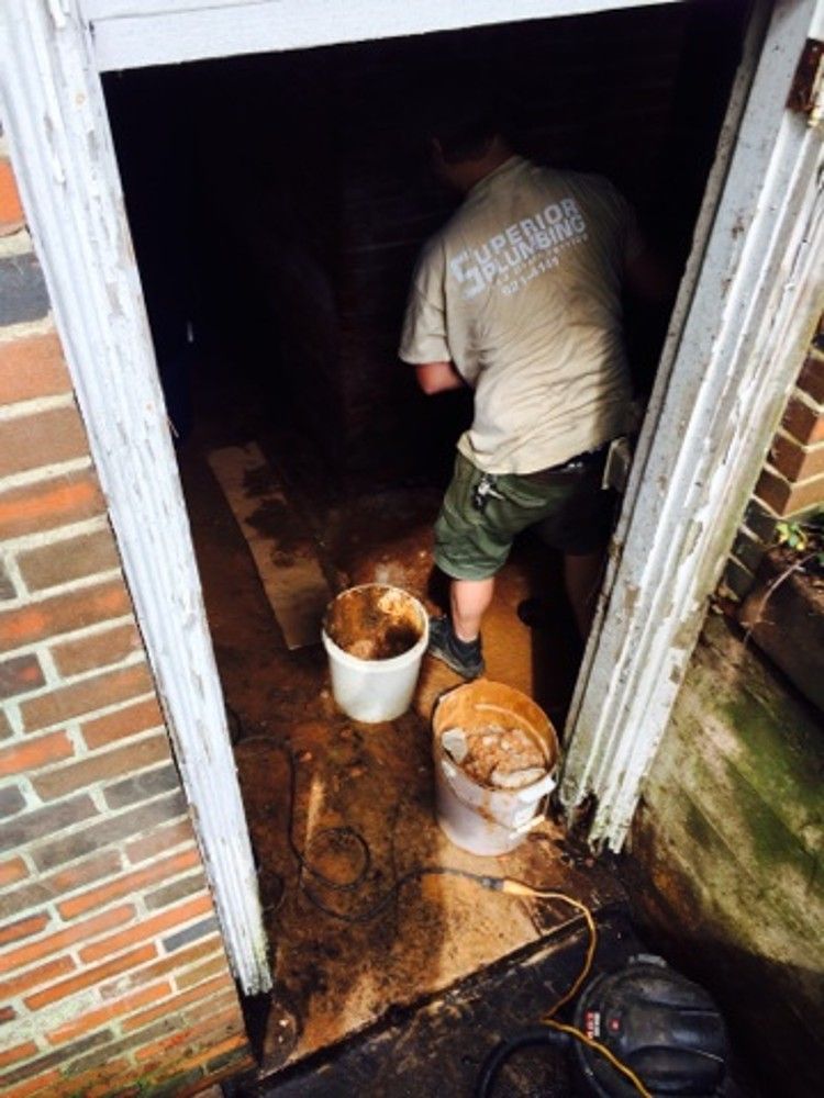 Carrying buckets of mud out of the basement