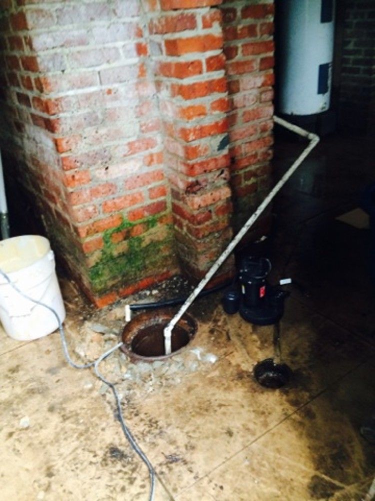 The pump set in the pit, with the discharge pipe up the wall