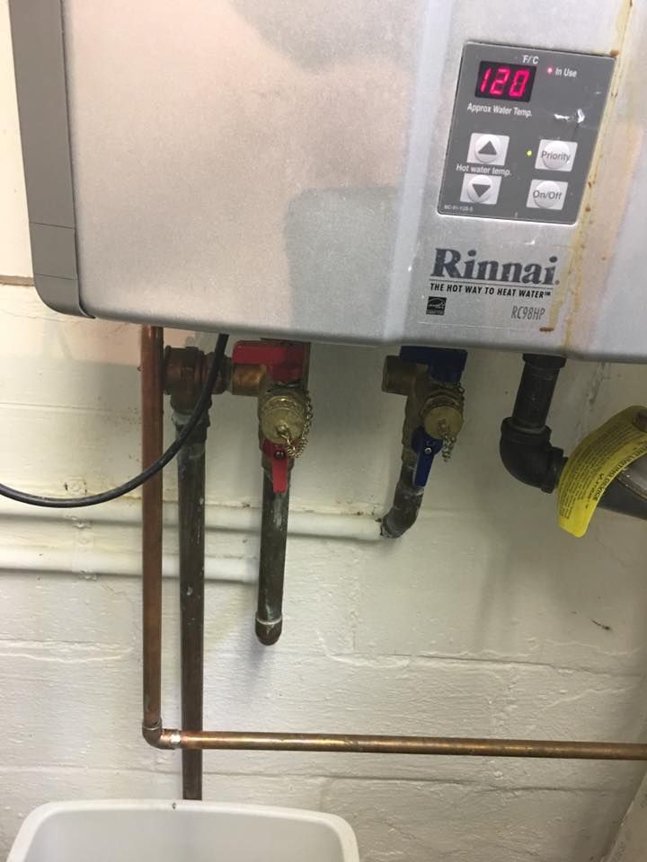 Pipe repaired below tankless water heater