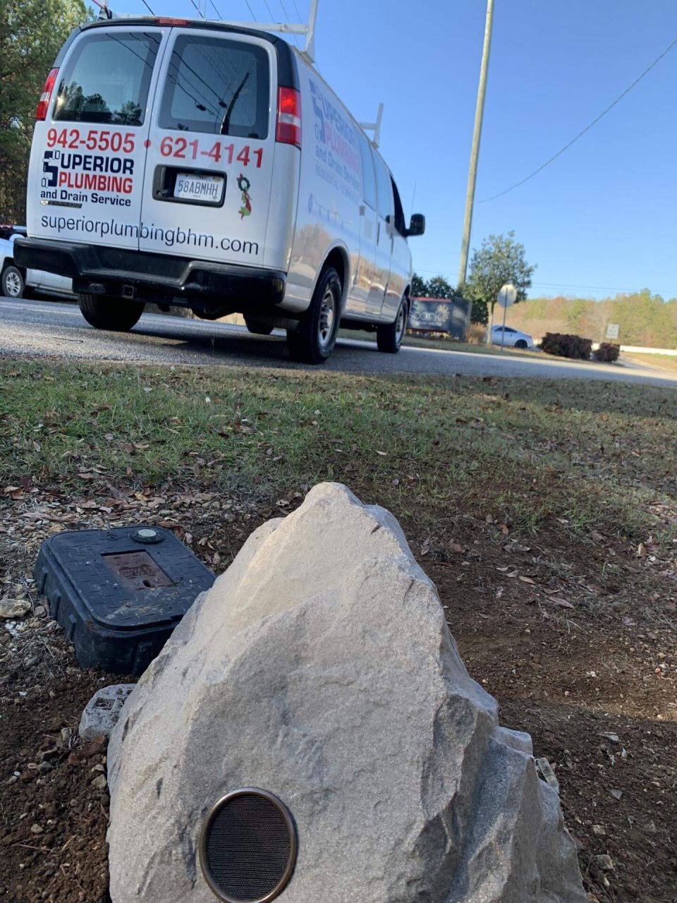 The rock cover next to the meter box, with our van behind